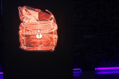  Lightbox image of “ bolsa de torpelo “ or red velvet bag used to carry the 1812 Cadiz Constitution, Spanish Parliament Archives ( Madrid ). On the walls are handwritten insights of the guest and visitors of the exhibit through chalk sticks and illuminated by dark lights to add character of their voice as individuals. This is in collaboaration with JuanBS. Photo credit: Michelle Lua